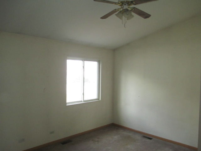 35322 North Wilson Road Ingleside, IL 60041 - Photo 4 of 18 an empty room with a window and a fan