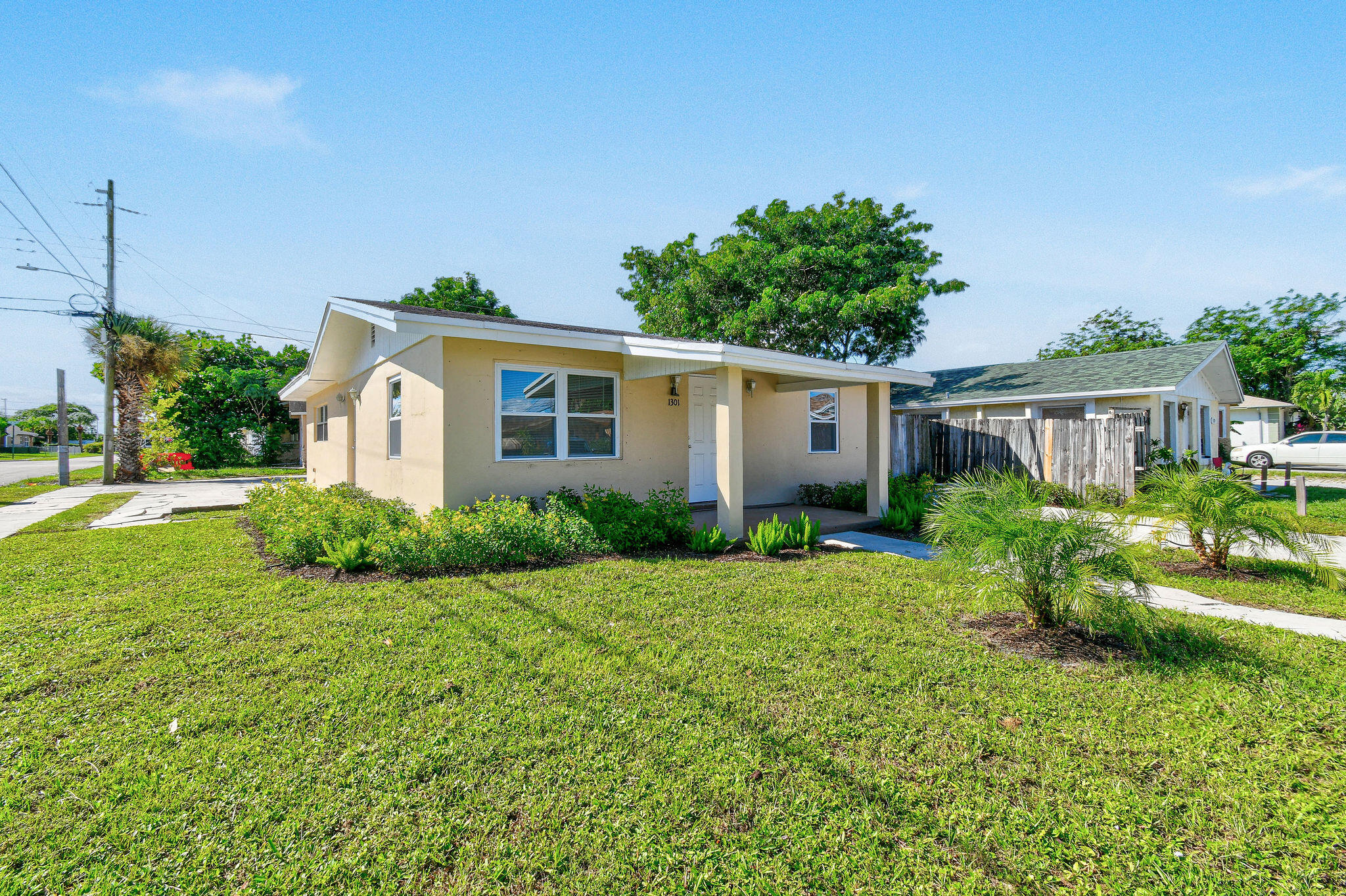 1301 West 25th Street Riviera Beach, FL 33404 - Photo 1 of 34 a view of backyard of house with green space