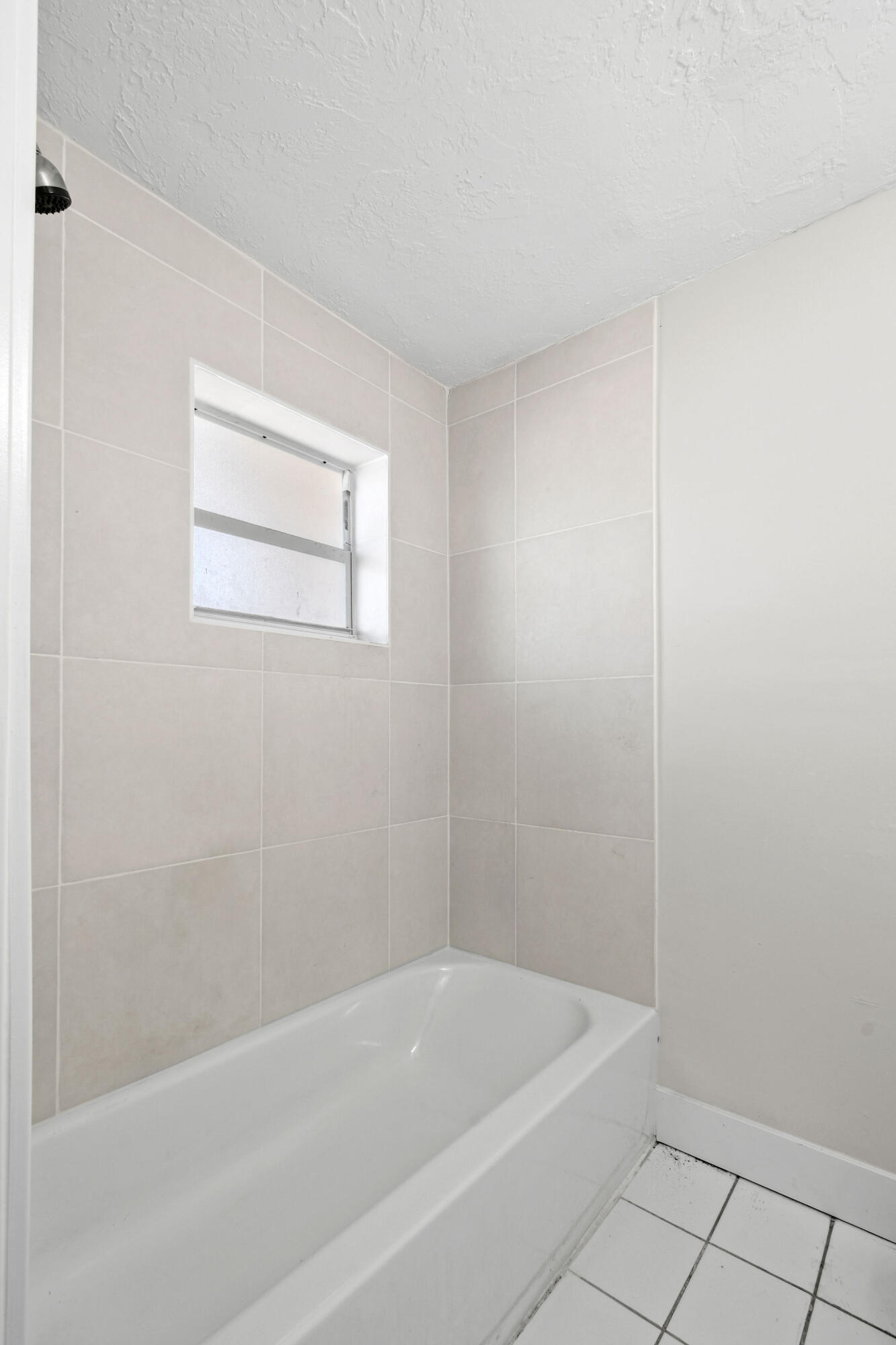 1301 West 25th Street Riviera Beach, FL 33404 - Photo 18 of 34 a white bath tub sitting next to a small window
