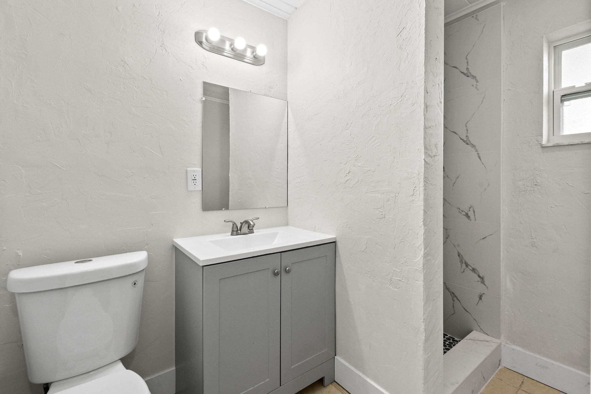 1301 West 25th Street Riviera Beach, FL 33404 - Photo 29 of 34 a bathroom with a toilet sink and mirror