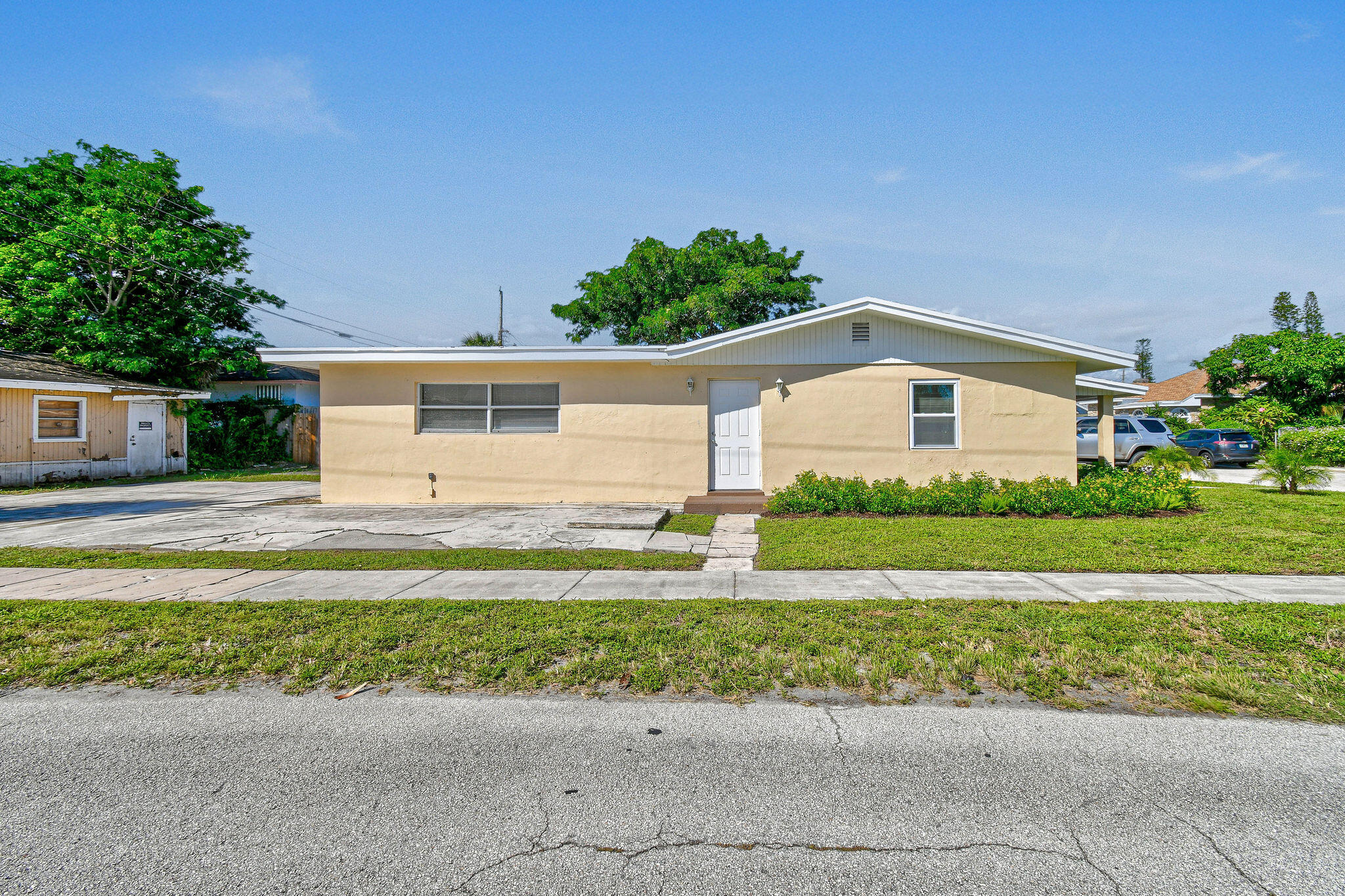 1301 West 25th Street Riviera Beach, FL 33404 - Photo 33 of 34 a front view of a house with a yard and garage
