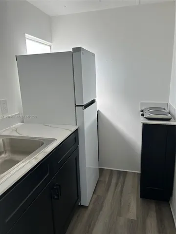 a kitchen with a sink and a refrigerator