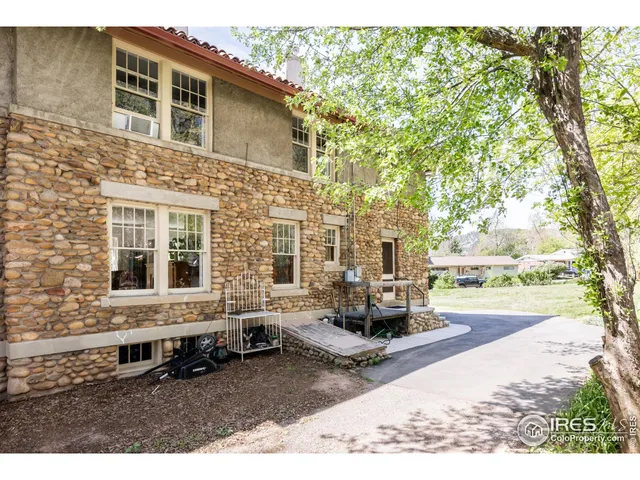 an aerial view of residential house with outdoor space and trees all around