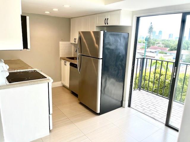 777 Southwest 9th Avenue, Unit 413 Miami, FL 33130 - Photo 12 of 36 a kitchen with stainless steel appliances a refrigerator and a gate