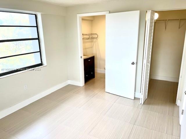 777 Southwest 9th Avenue, Unit 413 Miami, FL 33130 - Photo 14 of 36 a view of an empty room with wooden floor and a window
