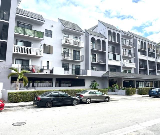 777 Southwest 9th Avenue, Unit 413 Miami, FL 33130 - Photo 30 of 36 a front view of a building with lot of cars and trees