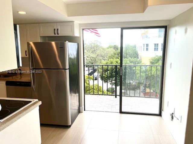 777 Southwest 9th Avenue, Unit 413 Miami, FL 33130 - Photo 3 of 36 a kitchen with a refrigerator a sink and a large window