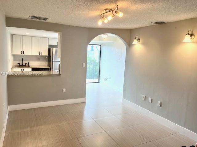 777 Southwest 9th Avenue, Unit 413 Miami, FL 33130 - Photo 4 of 36 a view of a kitchen with wooden floor and cabinets