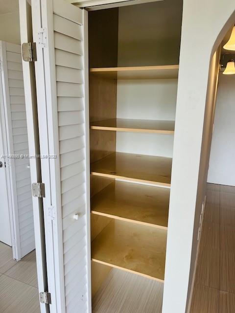 777 Southwest 9th Avenue, Unit 413 Miami, FL 33130 - Photo 6 of 36 a view of walk in closet with empty racks