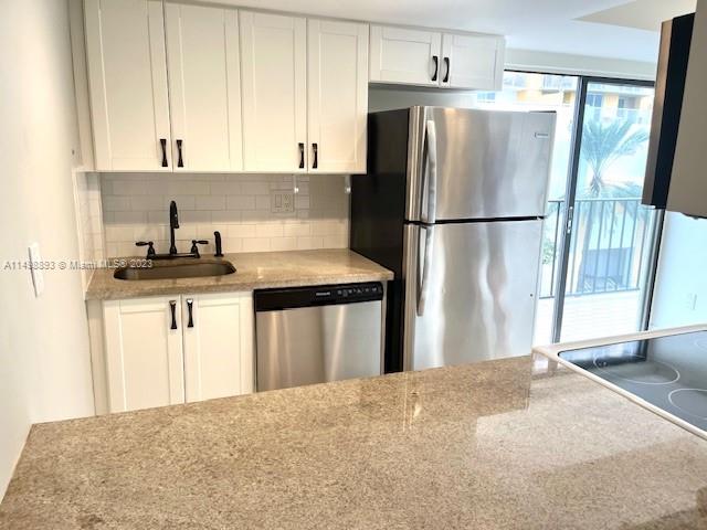 777 Southwest 9th Avenue, Unit 413 Miami, FL 33130 - Photo 10 of 36 a kitchen with kitchen island a counter top space and stainless steel appliances