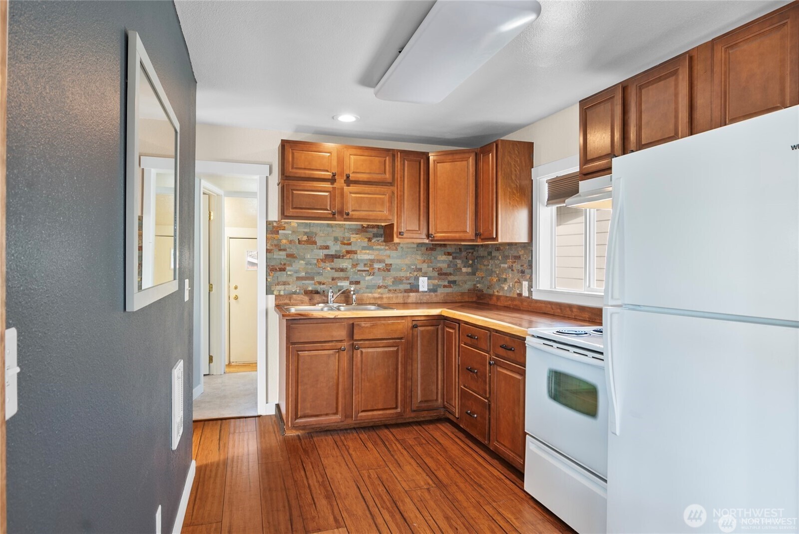1770 Marker Avenue Wenatchee, WA 98801 - Photo 5 of 32 a kitchen with stainless steel appliances granite countertop a refrigerator a sink dishwasher a stove and white countertops with wooden floor