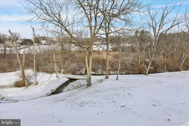 a view of empty space with wooden fence