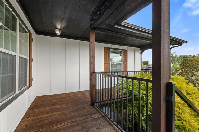 a view of a porch with wooden floor