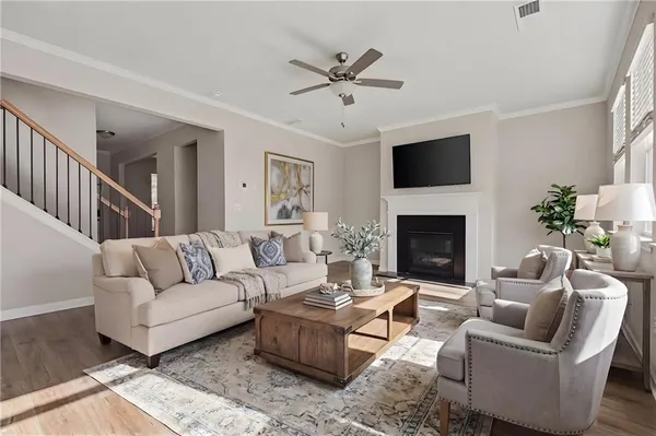 a living room with furniture a fireplace and a flat screen tv