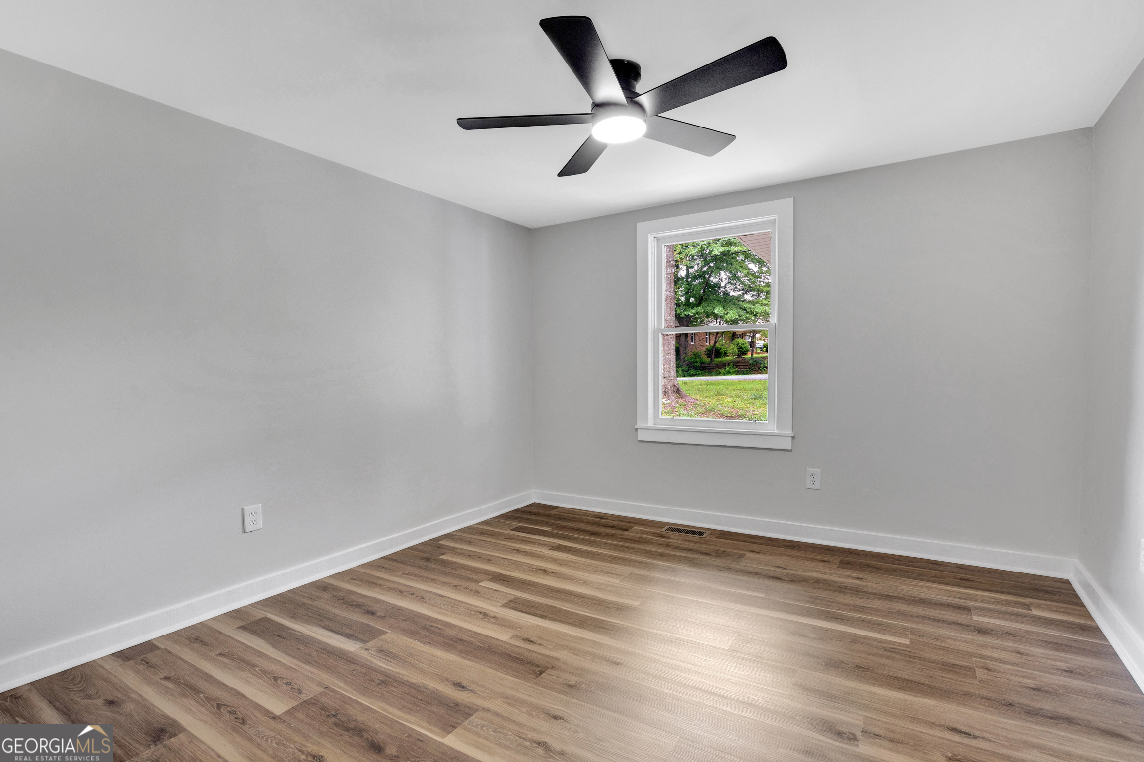 455 Cindy Street Jackson, GA 30233 - Photo 15 of 25 wooden floor in an empty room with a window