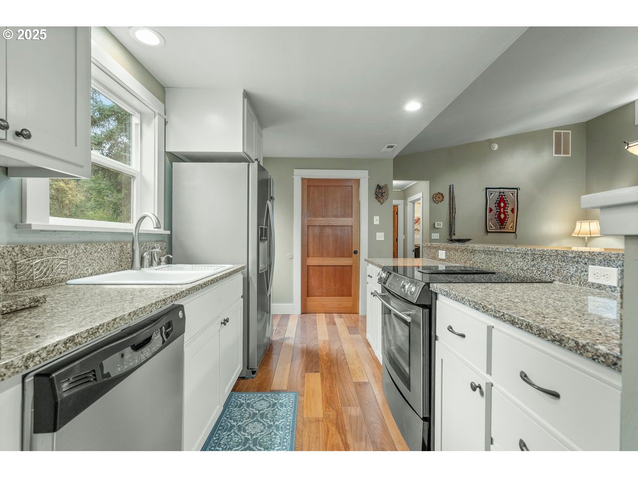 24781 Dunham Road Veneta, OR 97487 - Photo 9 of 22 a large kitchen with granite countertop a stove and a sink