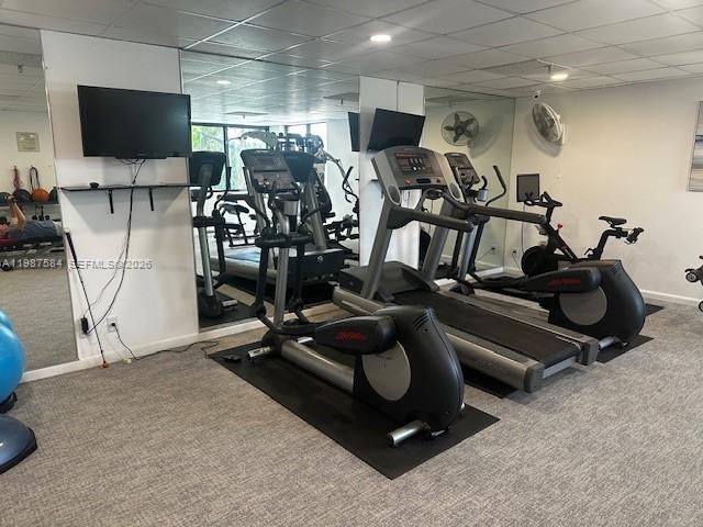 19670 South Beach Road, Unit B323 Tequesta, FL 33469 - Photo 15 of 31 a room with gym equipment and a flat screen tv