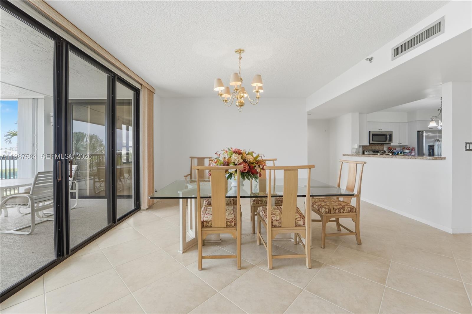 19670 South Beach Road, Unit B323 Tequesta, FL 33469 - Photo 16 of 57 a dining room with furniture and large window