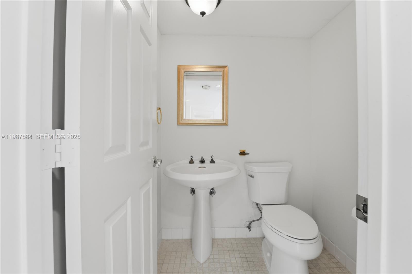 19670 South Beach Road, Unit B323 Tequesta, FL 33469 - Photo 19 of 57 a bathroom with a toilet a sink and mirror