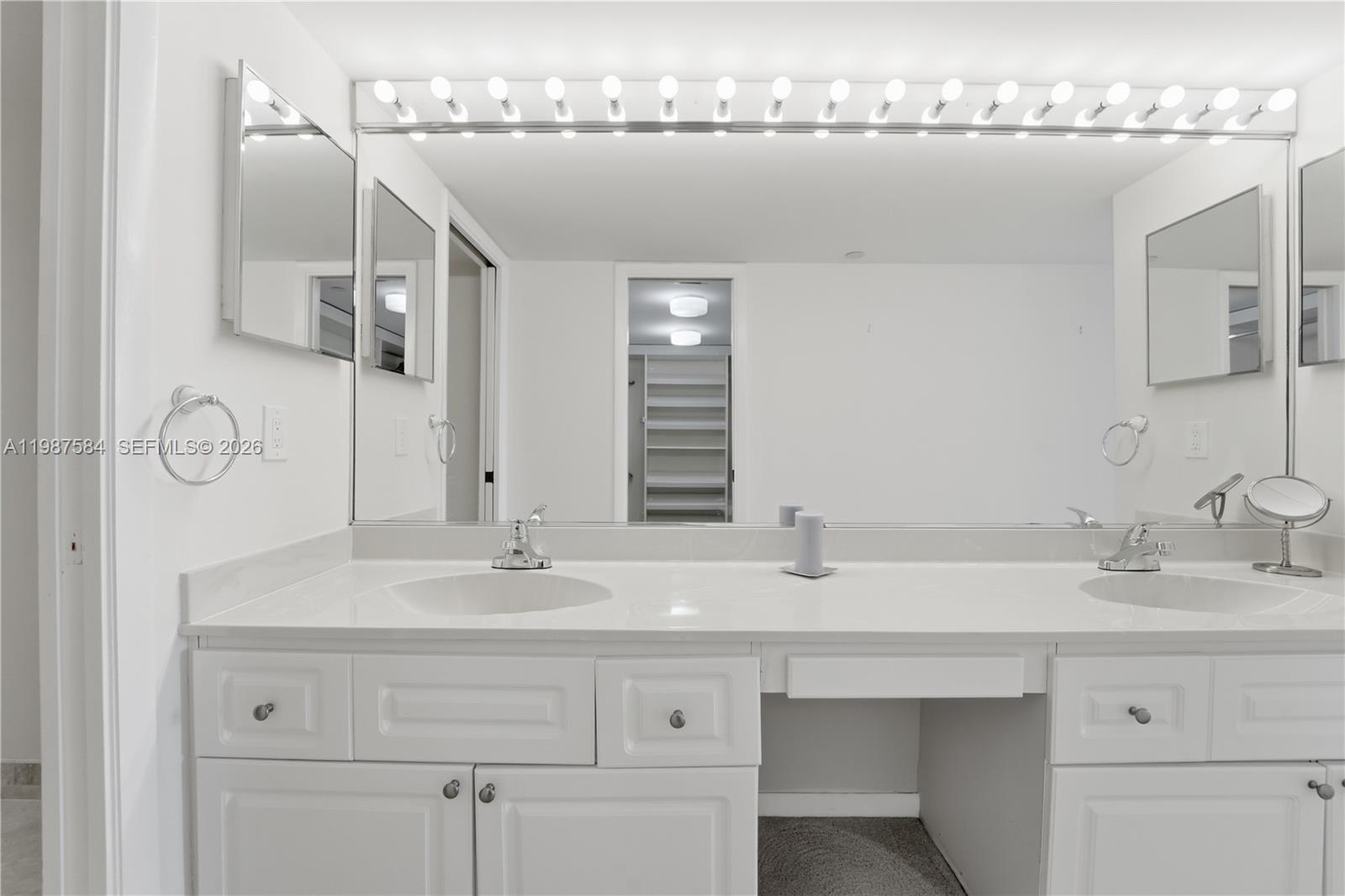 19670 South Beach Road, Unit B323 Tequesta, FL 33469 - Photo 25 of 57 a bathroom with a sink and a mirror