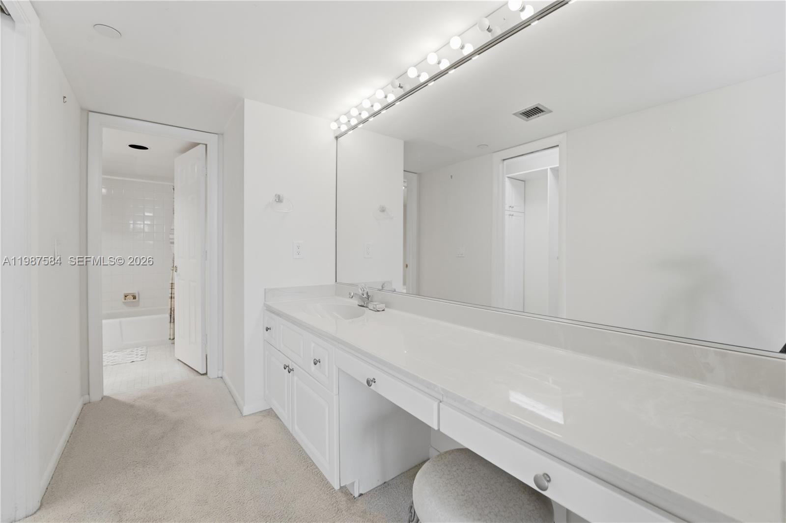 19670 South Beach Road, Unit B323 Tequesta, FL 33469 - Photo 32 of 57 a bathroom with a double vanity sink a toilet and shower