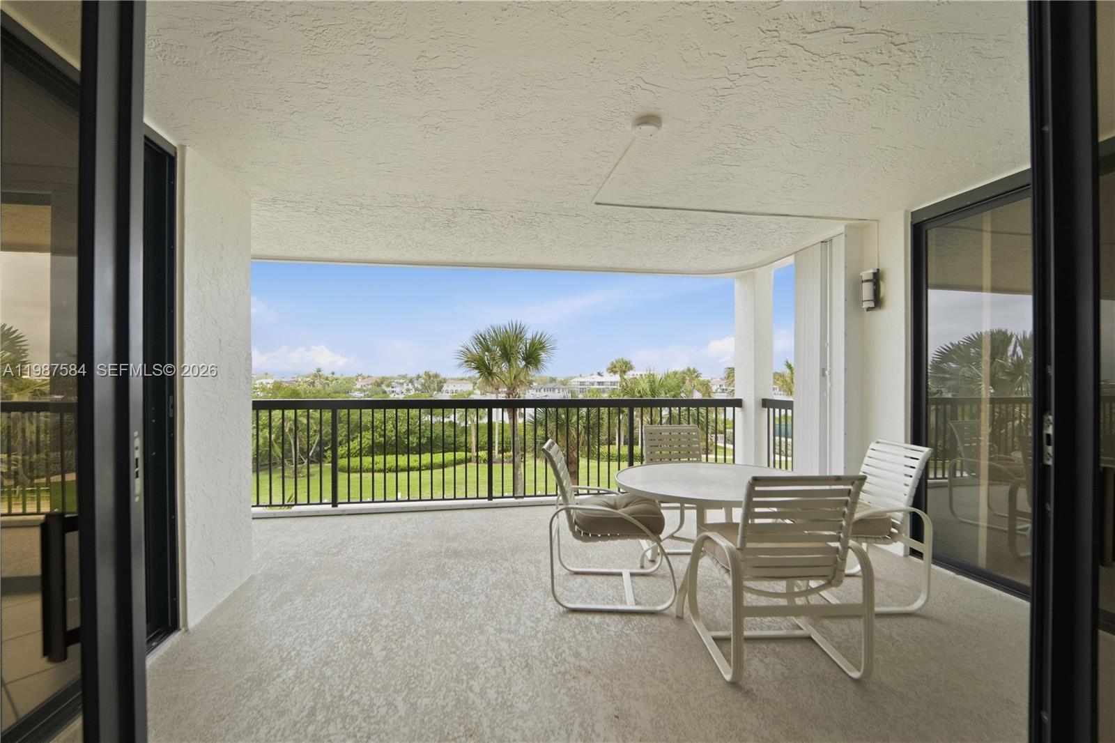 19670 South Beach Road, Unit B323 Tequesta, FL 33469 - Photo 33 of 57 a balcony with furniture and a floor to ceiling window