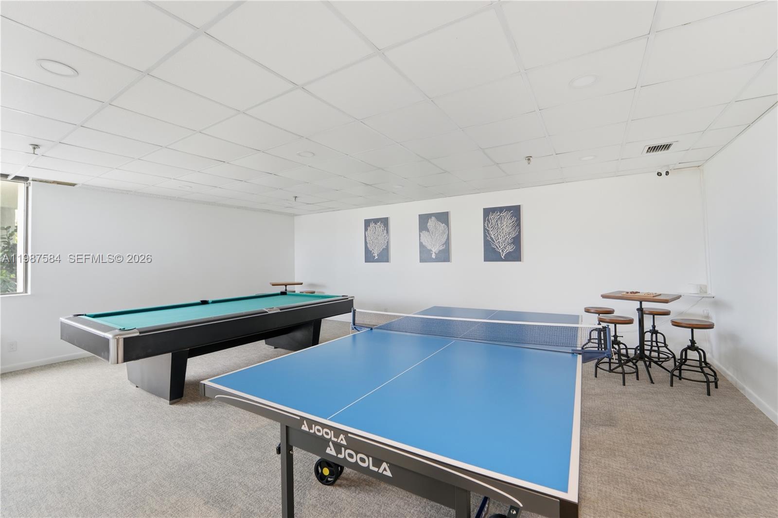 19670 South Beach Road, Unit B323 Tequesta, FL 33469 - Photo 49 of 57 a room with furniture pool table and windows