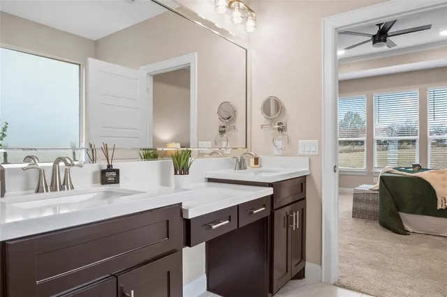 a bathroom with a granite countertop sink a large mirror and a shower