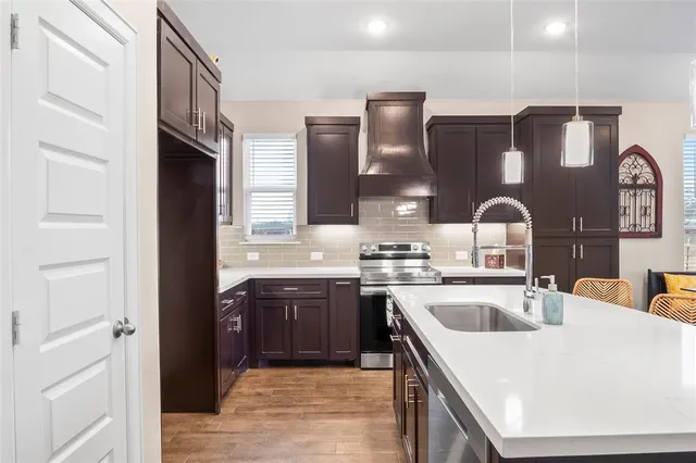 a kitchen with a sink stove and cabinets