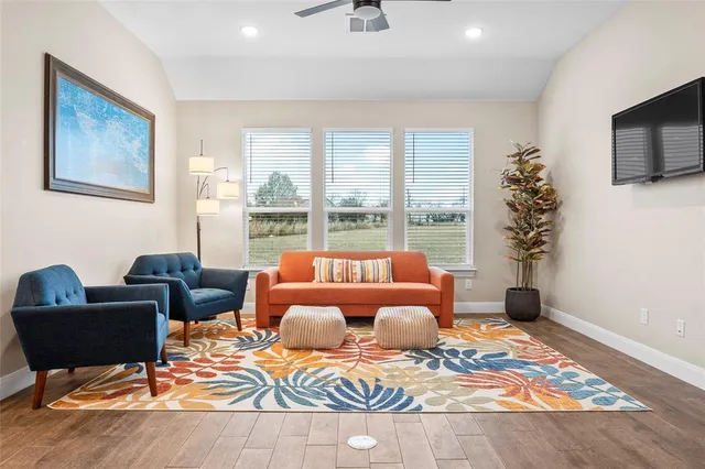 a living room with furniture fireplace and flat screen tv