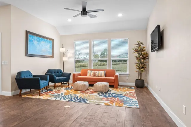a living room with furniture fireplace and flat screen tv