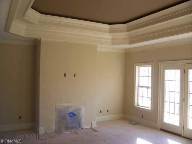 4001 Smith Ridge Court Colfax, NC 27235 - Photo 2 of 6 Other. Family Room with hardwood floors, crown molding, tray ceiling & gas log fireplace.
