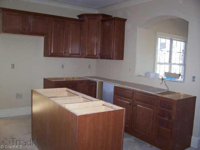 4001 Smith Ridge Court Colfax, NC 27235 - Photo 3 of 6 Other. Kitchen with tile floor, granite tops, tile back splash, arched doorway to sunroom.