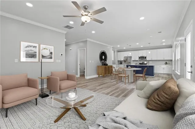 a living room with furniture and kitchen view