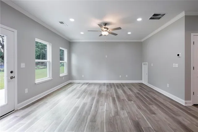 wooden floor in an empty room with a window