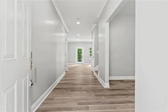a view of a hallway with wooden floor