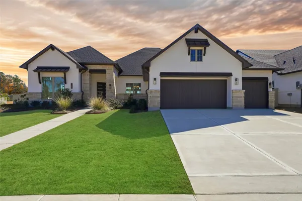 a front view of house with yard and green space