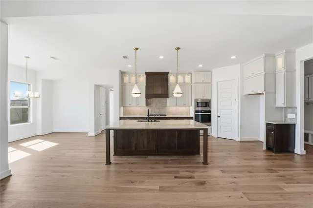 a view of kitchen with kitchen island stainless steel appliances sink and stove