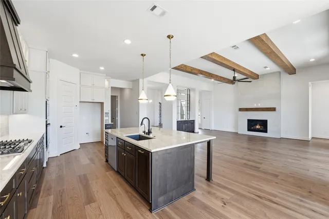 a kitchen with a stove a sink and a refrigerator