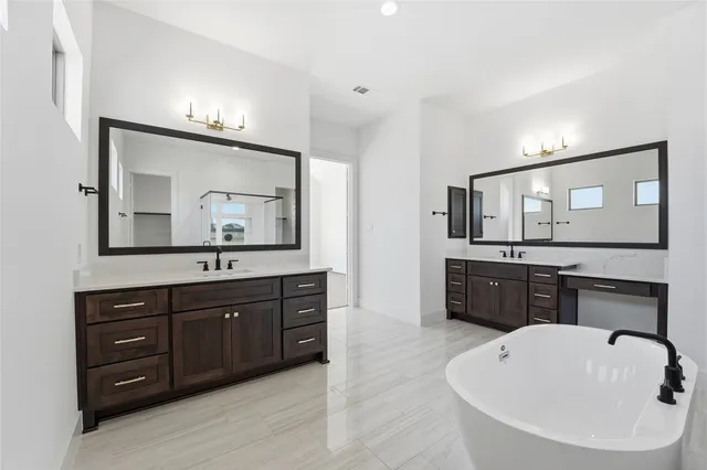 a bathroom with a bathtub sink and mirror