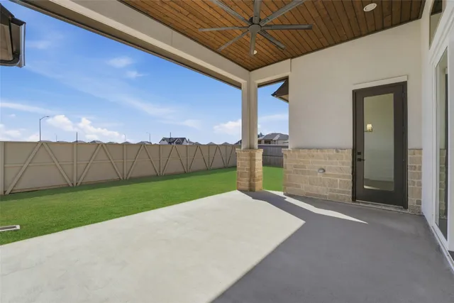 a view of a backyard with wooden fence