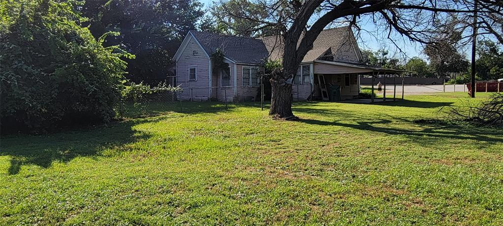 208 Optimist Springtown, TX 76082 - Photo 5 of 11 a front view of a house with garden