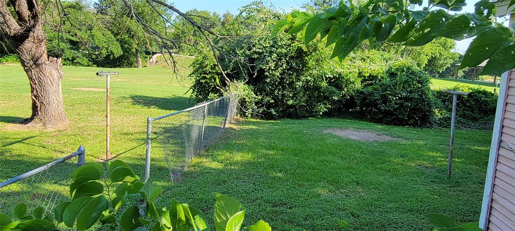 208 Optimist Springtown, TX 76082 - Photo 7 of 11 a view of a chair and table in the garden