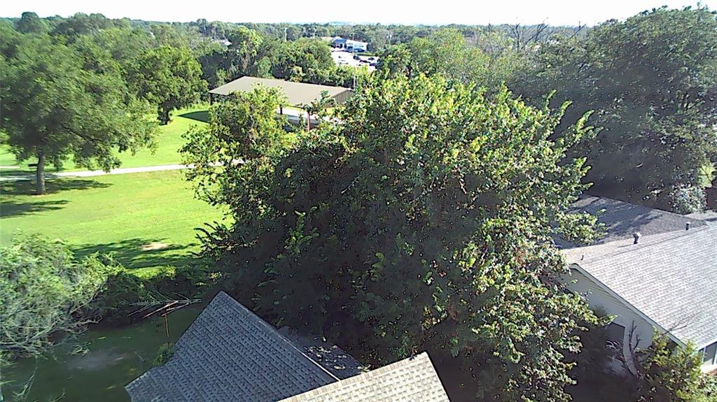208 Optimist Springtown, TX 76082 - Photo 10 of 11 a view of a yard with plants and a bench