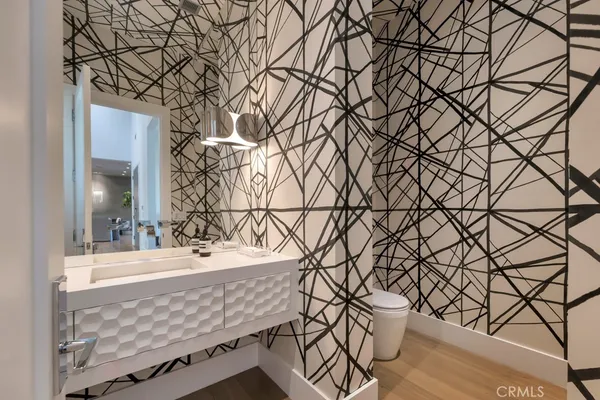 a large white kitchen with a large window and stainless steel appliances