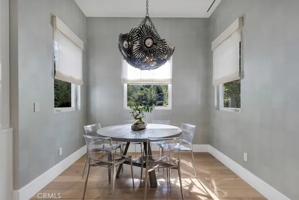 a bathroom with a sink and a large mirror next to a window