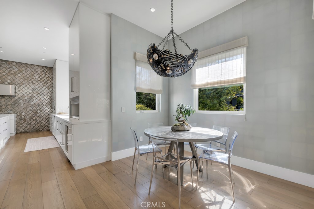 17950 Rancho Street Encino, CA 91316 - Photo 17 of 75 a view of a dining room with furniture window and wooden floor