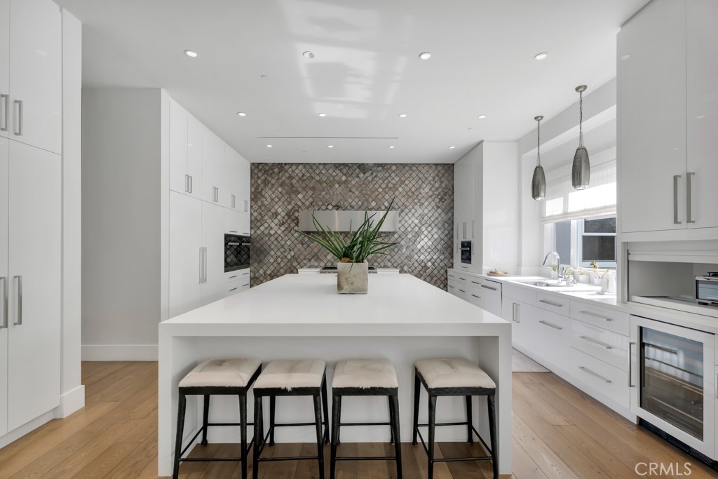 17950 Rancho Street Encino, CA 91316 - Photo 19 of 75 a kitchen with a table and chairs in it