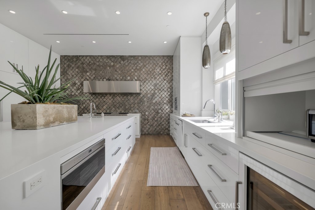 17950 Rancho Street Encino, CA 91316 - Photo 21 of 75 a large kitchen with a large counter top