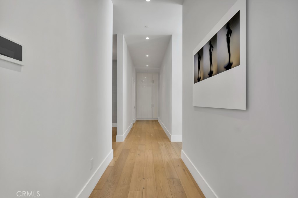 17950 Rancho Street Encino, CA 91316 - Photo 28 of 75 a view of a hallway with wooden floor and staircase